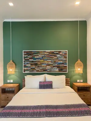 a bedroom with a white bed and green walls at FANTASTIC 1 BR VILLA PRIVATE POOL WALK TO BEACH in Badung