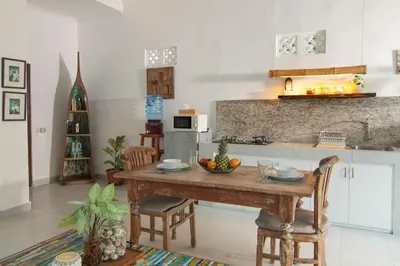 a kitchen with a table with a bowl of fruit on it at FANTASTIC 1 BR VILLA PRIVATE POOL WALK TO BEACH in Badung