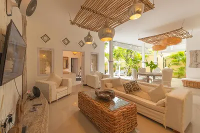 a living room with white couches and a table at Smile - One Bedroom Villa in the Seminyak center in Seminyak