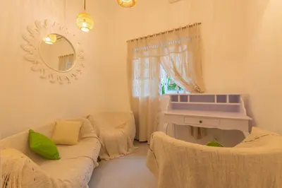 a living room with a couch and a mirror at Smile - One Bedroom Villa in the Seminyak center in Seminyak