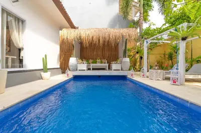 a swimming pool in a house with a villa at Smile - One Bedroom Villa in the Seminyak center in Seminyak