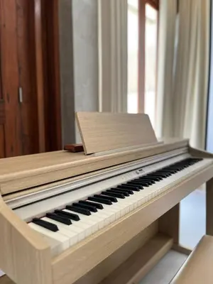a wooden piano sitting in a room at Wakajima House Kuta Utara in Kerobokan