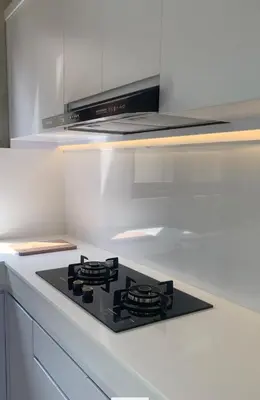 a kitchen with a black stove top in a kitchen at Wakajima House Kuta Utara in Kerobokan