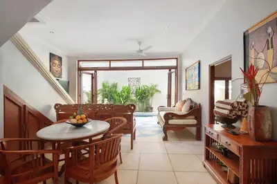 a living room with a table and chairs at Legian Blue Ocean Villa in Seminyak