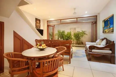 a dining room with a table and chairs at Legian Blue Ocean Villa in Seminyak
