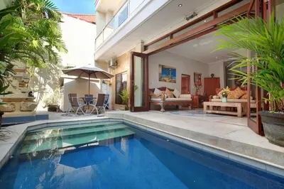 a swimming pool in a villa with a house at Legian Blue Ocean Villa in Seminyak