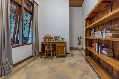 a room with a desk and a chair and a window at Castila Saraswati - Tranquil 4BR Villa in Kayu Aya in Seminyak