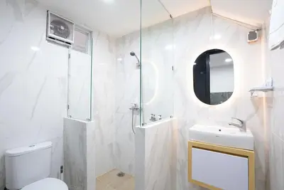 a bathroom with a shower and a toilet and a sink at Mezzanine Luxury Smart Room - Sanur in Sanur