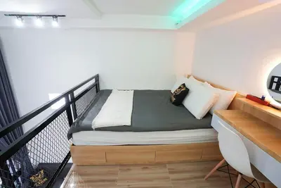 a small bedroom with a bed on a balcony at Mezzanine Luxury Smart Room - Sanur in Sanur