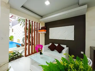 a living room with a couch and a table at Thapleuk Residence in Nusa Dua