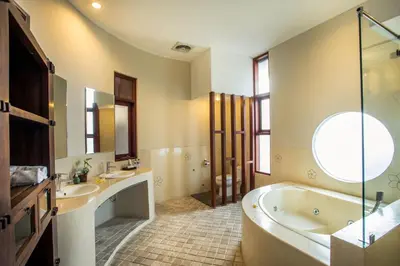 a large bathroom with two sinks and a tub at Villa Tantri in Kerobokan