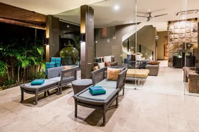 a living room with chairs and a couch at Cicada Luxury Townhouses in Seminyak