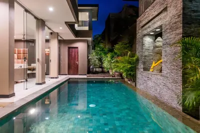 a swimming pool in the middle of a house at Cicada Luxury Townhouses in Seminyak