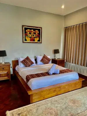 a bedroom with a large bed in a room at Blue Diamond Residenses Seminyak in Seminyak