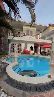 a large swimming pool in front of a house at Blue Diamond Residenses Seminyak in Seminyak