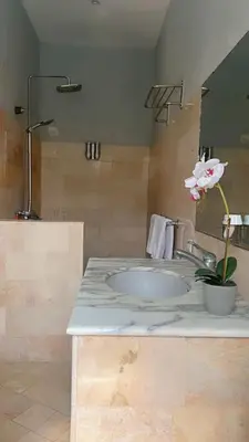 a bathroom with a sink and a mirror at Blue Diamond Residenses Seminyak in Seminyak