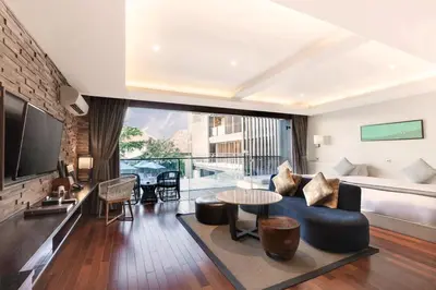 a living room with a couch and a table at Watermark Hotel & Spa Bali in Jimbaran