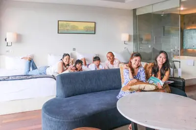 a group of people sitting on a couch in a living room at Watermark Hotel & Spa Bali in Jimbaran