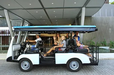 a group of people sitting in a golf cart at Watermark Hotel & Spa Bali in Jimbaran