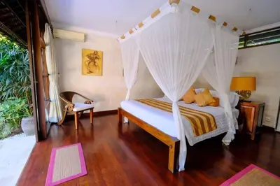 a bedroom with a bed with a canopy at Villa Jepun Seminyak in Canggu