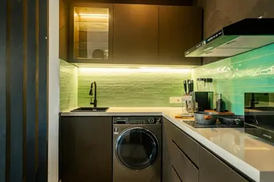 a kitchen with a washing machine and a sink at Central Cozy Villa 3BR 5min walk to shops, beach in Legian