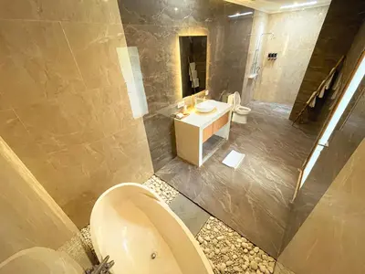 a large bathroom with a toilet and a sink at Villa Sinergi Seminyak 6 in Seminyak