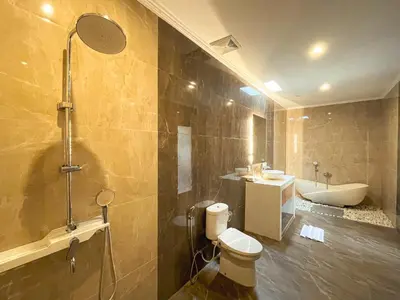 a bathroom with a toilet and a shower and a sink at Villa Sinergi Seminyak 6 in Seminyak