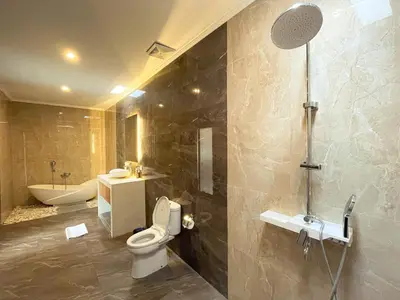 a bathroom with a toilet and a sink and a shower at Villa Sinergi Seminyak 6 in Seminyak