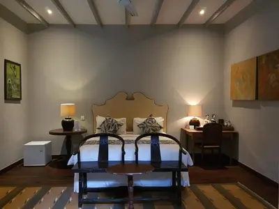 a bedroom with a bed and a table and a desk at Room & Vespa 3 - Relaxing Stay Center Seminyak in Seminyak