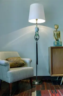 a lamp sitting next to a chair next to a couch at Room & Vespa 3 - Relaxing Stay Center Seminyak in Seminyak