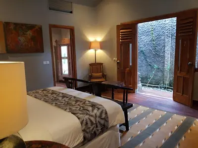 a bedroom with a bed and a desk and a window at Room & Vespa 3 - Relaxing Stay Center Seminyak in Seminyak