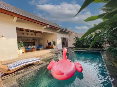 a pool with a pink inflatable rubber duck in a house at Villa Sinergi Seminyak 5 in Seminyak