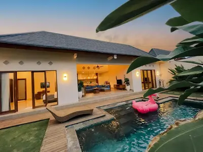 a house with a pool with a pink float in it at Villa Sinergi Seminyak 5 in Seminyak