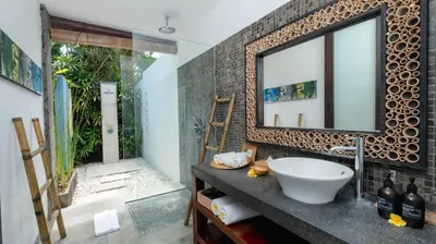 a bathroom with a sink and a mirror at Villa Anjali Blue by Villa Finder in Seminyak