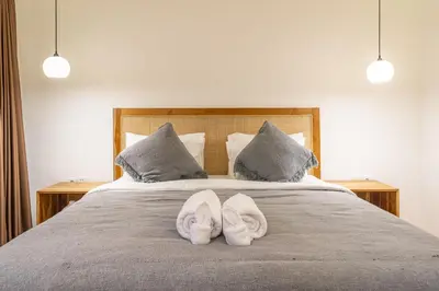 a bed with two white towels on top of it at Lekatica- 2BR Paradise Villa with Expansive Pool in Seminyak
