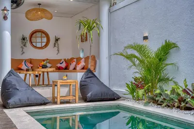 a house with a swimming pool and a couch at 3 Bed Cozy Mediterranean-Style Escape in Berawa in Canggu