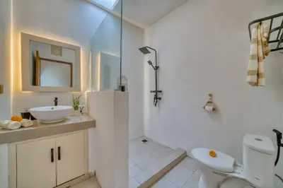 a white bathroom with a sink and a toilet at 3 Bed Cozy Mediterranean-Style Escape in Berawa in Canggu