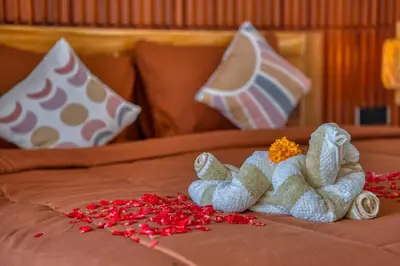 a bed with two stuffed animals and red rose petals at 3 Bed Cozy Mediterranean-Style Escape in Berawa in Canggu
