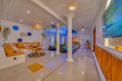 a living room with a large aquarium in the wall at 3 Bed Cozy Mediterranean-Style Escape in Berawa in Canggu