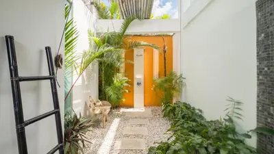 an entrance to a house with an orange door at Villa Anjali Orange by Villa Finder in Seminyak