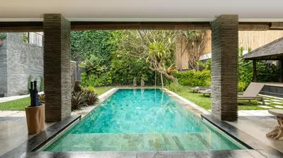 a swimming pool in the middle of a yard at Villa Anjali Orange by Villa Finder in Seminyak