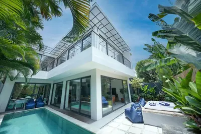 a villa with a swimming pool and a house at Twin Villas Cora & Zeno by Exotic Bali Properties in Seminyak