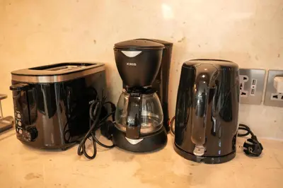 two coffeemakers sitting next to each other on a counter at Twin Villas Cora & Zeno by Exotic Bali Properties in Seminyak