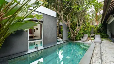 a swimming pool in the backyard of a house at Villa Anjali Purple by Villa Finder in Seminyak