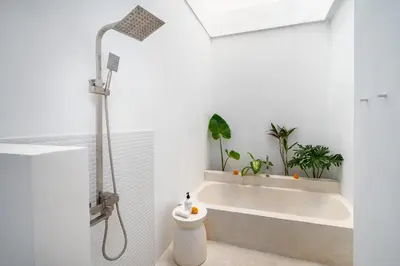 a bathroom with a bath tub with potted plants at Villa Mandara Double Six in Legian