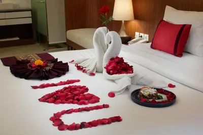a bed with roses and a swan made out of flowers at Nadi Hotel Legian in Legian