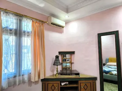 a bedroom with a mirror and a dresser and a bed at Villa Yoni in Bali in Pesanggaran