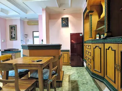 a kitchen with a wooden table and a wooden counter at Villa Yoni in Bali in Pesanggaran