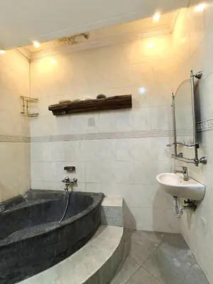 a bathroom with a bath tub and a sink at Villa Yoni in Bali in Pesanggaran