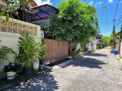 a street with a house with a fence and trees at Villa Yoni in Bali in Pesanggaran